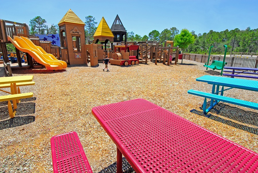 Colorful picnic tables near playground